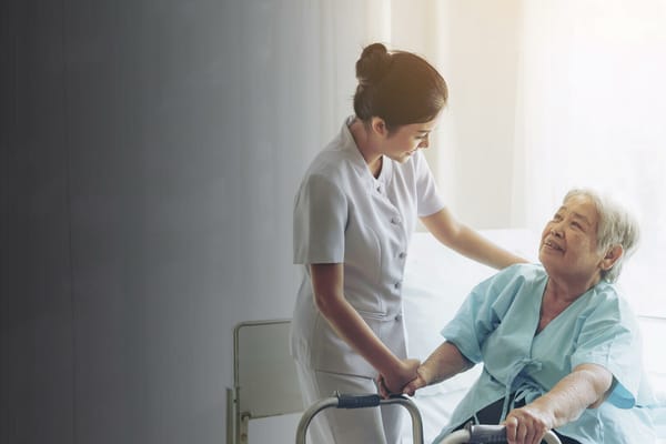 Nurse assisting an elderly resident in a bright room