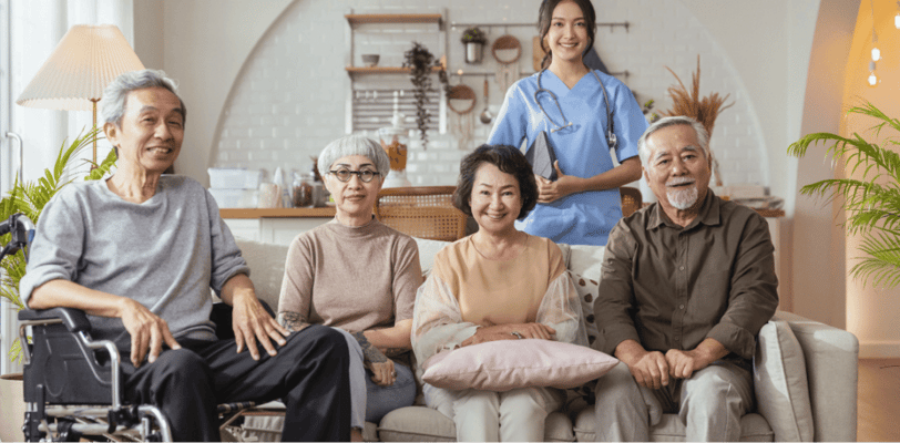 Residents and staff smiling together in a common area
