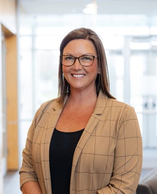Staff member smiling in a facility lobby