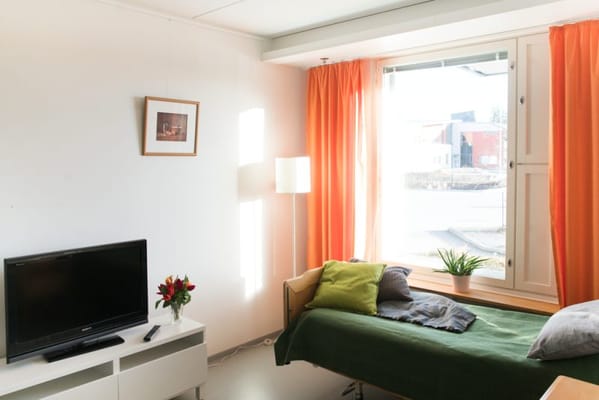 Bright interior of a resident room with a window and decorative elements
