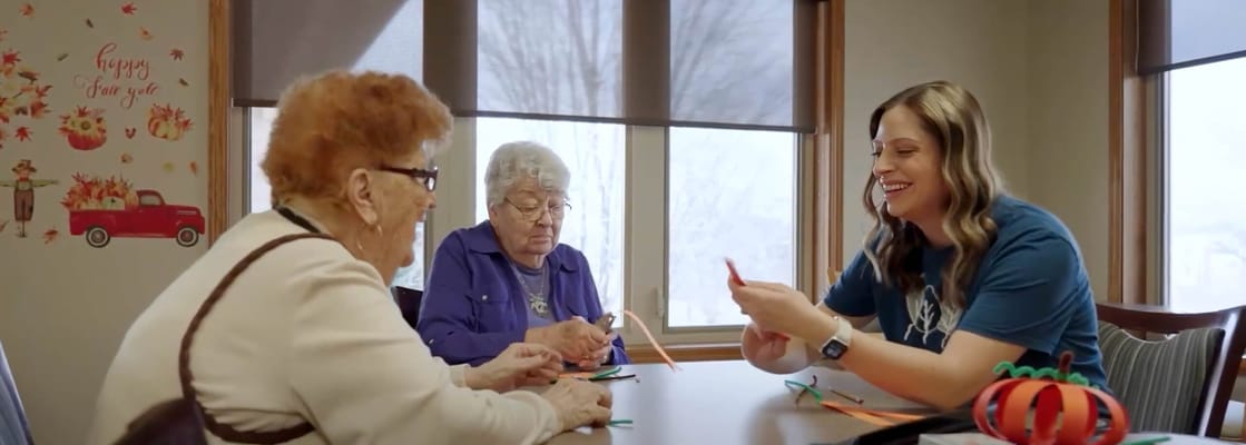 Residents and staff engaged in a crafting activity