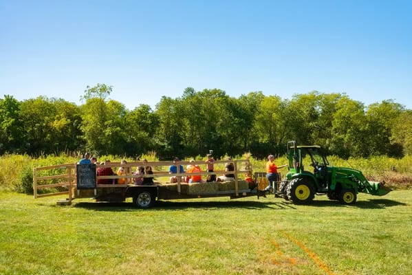 Residents enjoying a hayride on a sunny day