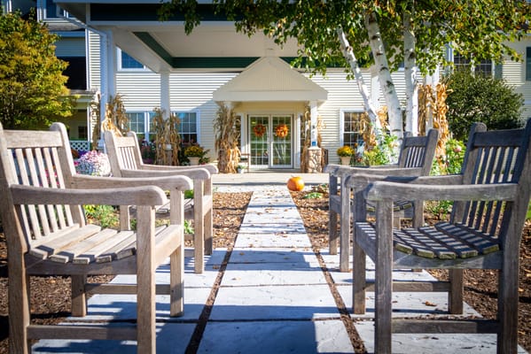 Outdoor seating area with a pathway leading to the entrance