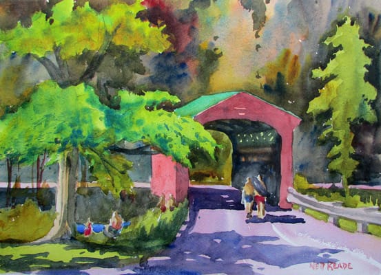 A scenic view of a facility entrance with trees