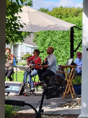Live music performance outside with residents enjoying