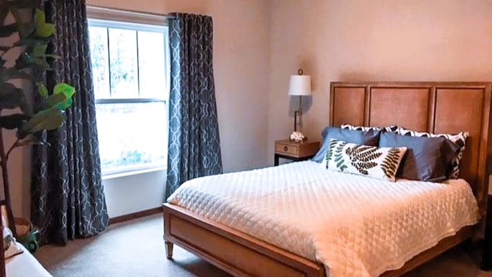 Cozy bedroom with a window and decorated bed