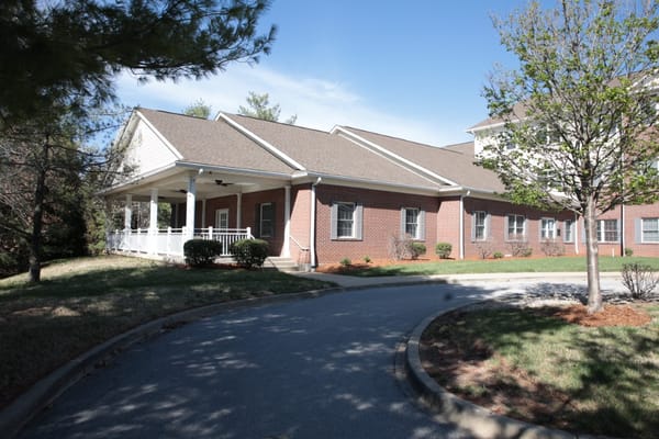 Exterior of The Willows at Springhurst showing the entryway and landscaping.
