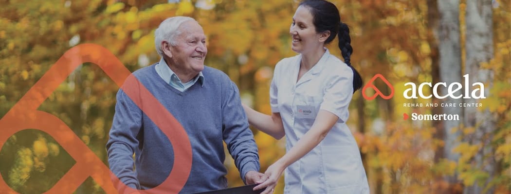 Caregiver assisting a resident outdoors in autumn