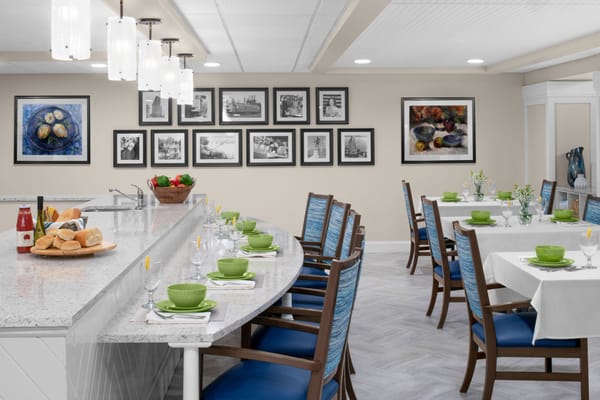 Bright dining area with tables set for meals at Anchor Bay at Pocasset.