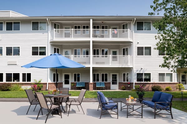Patio area with seating and umbrellas in front of the building