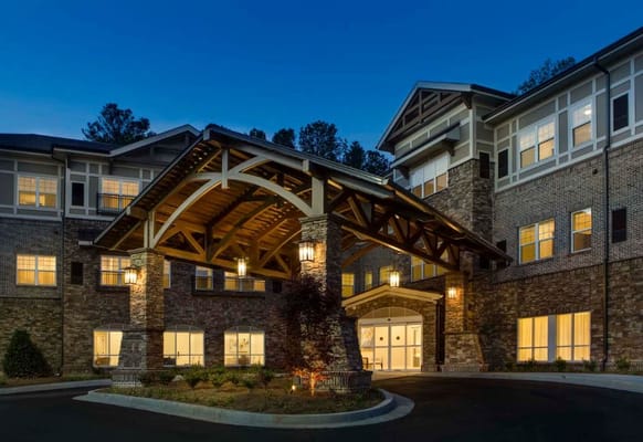 Exterior view of Arbor Terrace facility at dusk