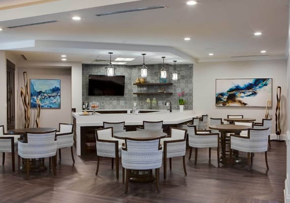 A well-lit common area with seating and artwork