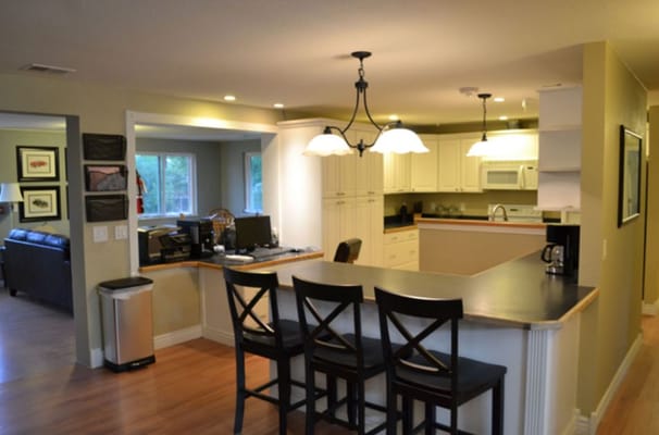 Brightly lit kitchen area with seating