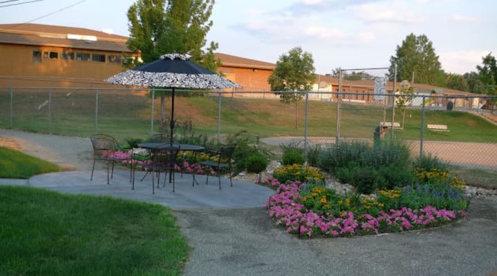 Outdoor seating area with flowers and patio umbrella