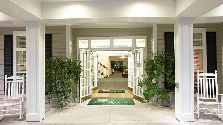 Entrance to Atria Forest Lake with rocking chairs and plants