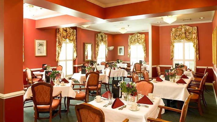 Elegant dining room setup with tables and flowers