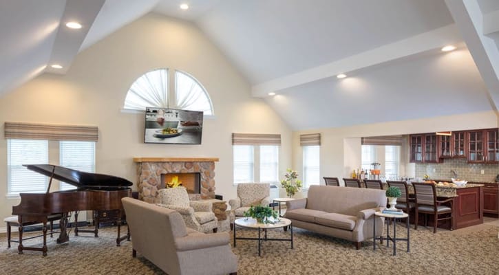 Bright common area with seating and piano