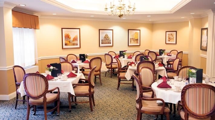 Elegant dining room setup with tables and flowers