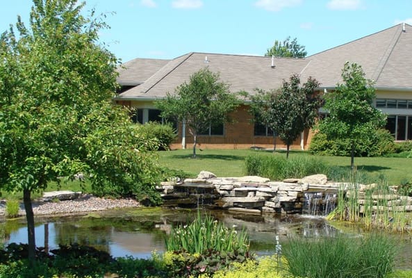 Beautiful outdoor space with a pond and landscaping