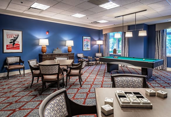A recreation room featuring a pool table and seating area.