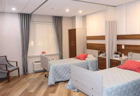 Bright interior of a resident room with two beds