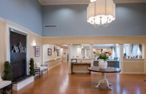Lobby area with seating and decorative chandelier
