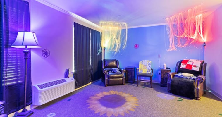 Interior of a sensory room with soft lighting and comfortable seating