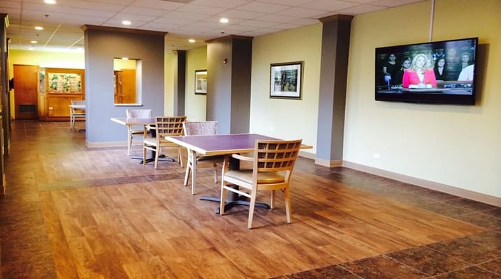 Common area with tables and a TV