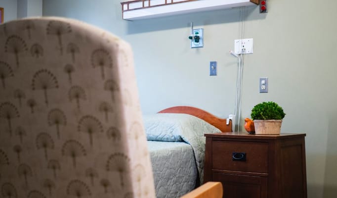 Cozy resident room with a bedside table and plants