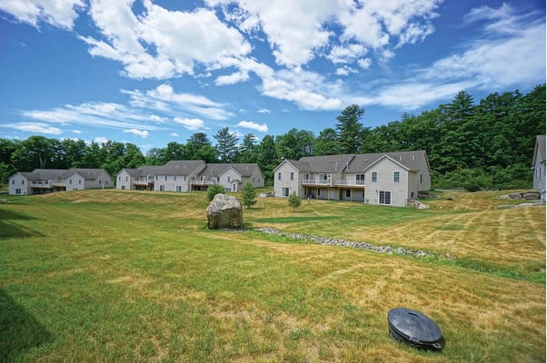 Lush green space with residential buildings at Black Rocks Village