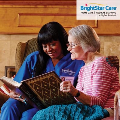 Caregiver reading with a resident in a cozy setting