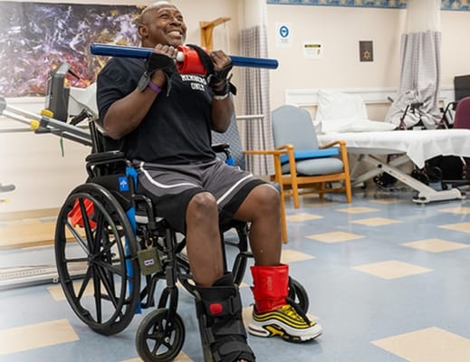 Resident exercising in an activity room