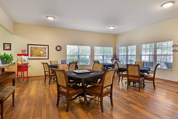 Common area with chairs and tables in an assisted living facility