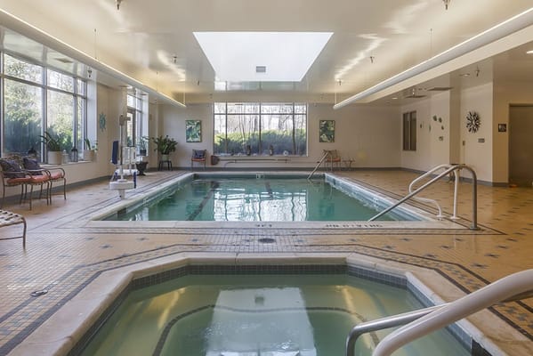 Indoor pool area with skylights and seating