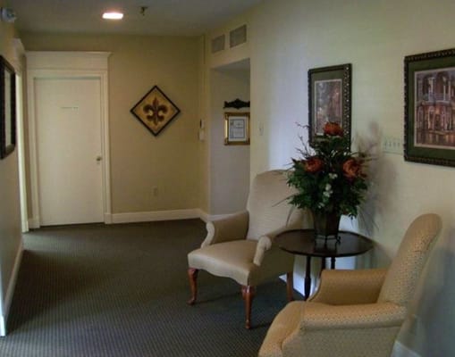 Cozy hallway with two chairs and a small table adorned with flowers