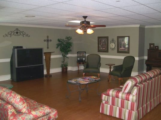 Comfortable seating in a cozy common area with a TV and decor