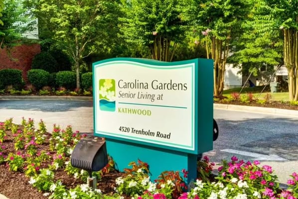 Sign for Carolina Gardens at Kathwood with flower beds