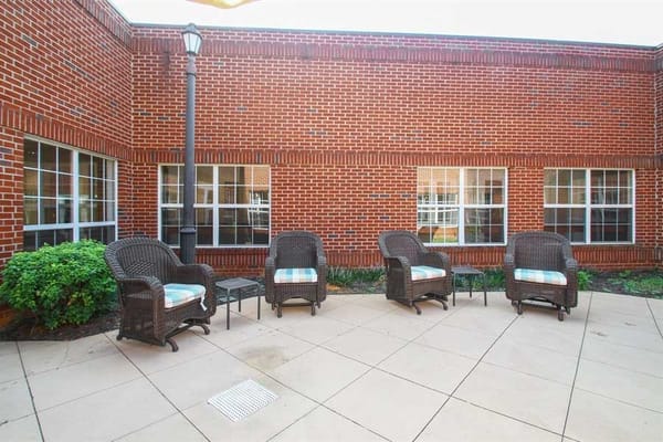 Outdoor seating area with wicker chairs and tables