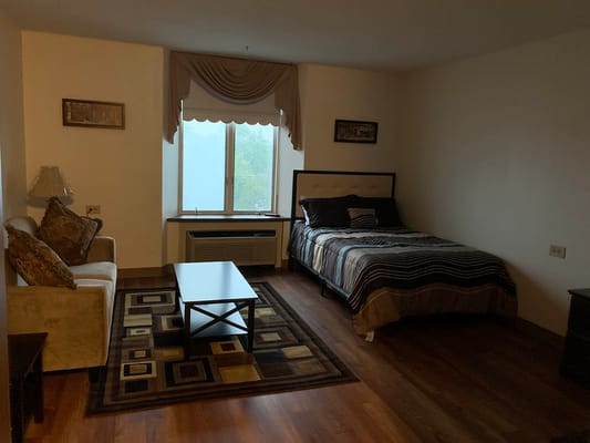 Cozy resident room with bed and seating area