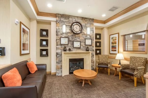A cozy common area with seating and a fireplace