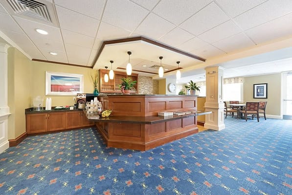 Interior view of a common area with seating and a coffee station