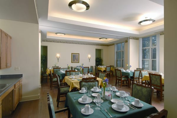 Dining room with neatly set tables and light decor