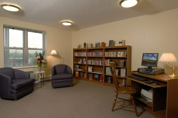 Cozy interior common area with seating and bookshelves