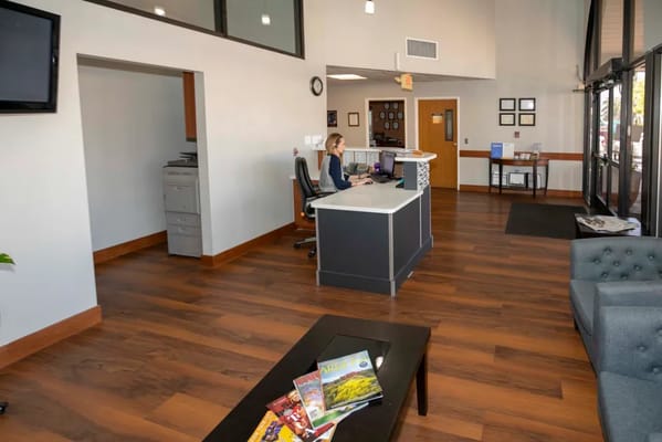 A woman at the reception desk in a modern lobby