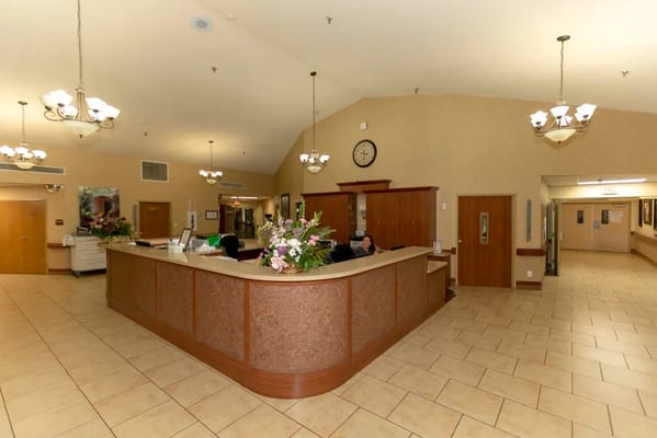 Reception area with a front desk and people