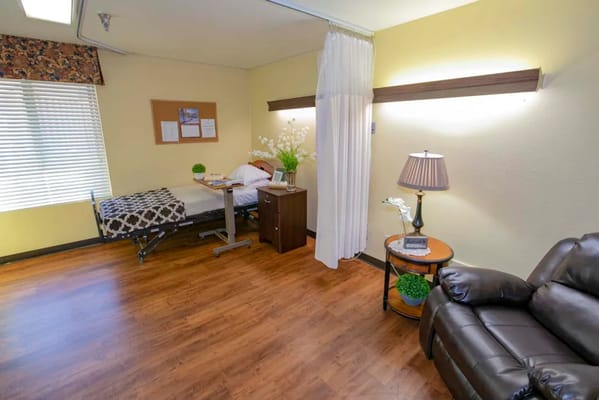 A private room with a bed and seating area