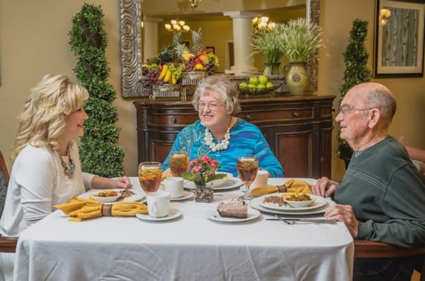 Residents enjoying a meal together in the dining room