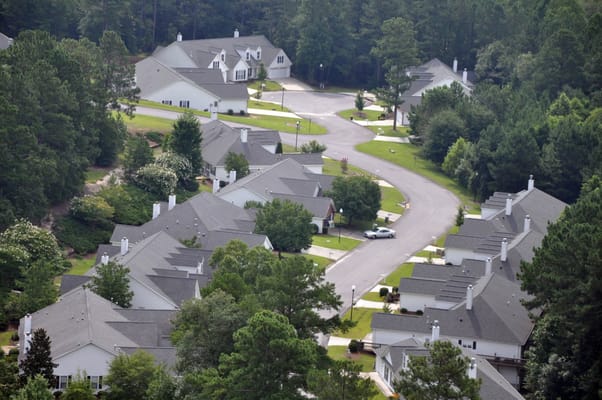 Aerial view of a residential community with homes and landscaping