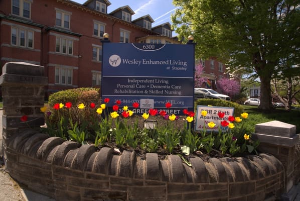 Exterior view of Wesley Enhanced Living at Stapeley with flowers