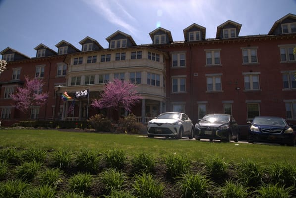 Exterior view of Wesley Enhanced Living facility with blooming trees